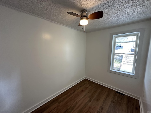 807 Walnut St, Oolitic, IN 47451 - spare room featuring dark wood-style flooring, a textured ceiling, baseboards, and a ceiling fan