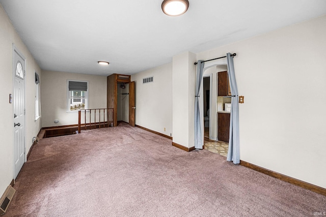 empty room with carpet floors and baseboards