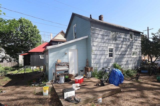 517 S Ninth St, Elkhart, IN 46516 - back of house with a deck, fence, and a chimney