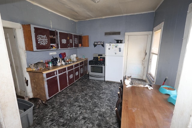 517 S Ninth St, Elkhart, IN 46516 - kitchen featuring freestanding refrigerator and stainless steel gas stove