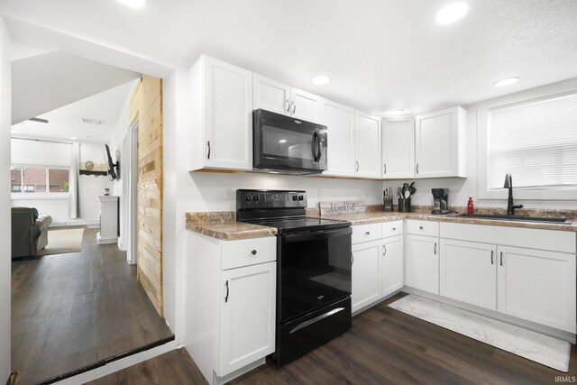 414 Monroe St, Monroeville, IN 46773 - kitchen with black appliances, a sink, dark wood-type flooring, white cabinets, and recessed lighting