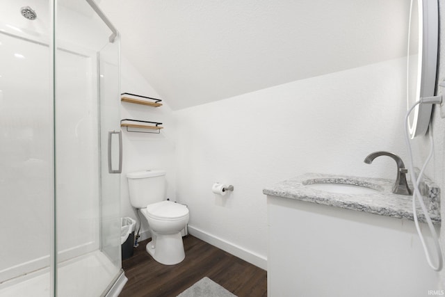 414 Monroe St, Monroeville, IN 46773 - full bathroom with a shower stall, vaulted ceiling, toilet, wood finished floors, and baseboards
