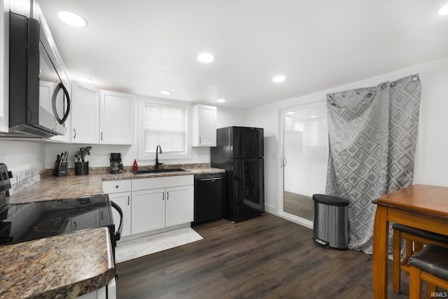 414 Monroe St, Monroeville, IN 46773 - kitchen with black appliances, a sink, white cabinetry, dark wood-style floors, and recessed lighting