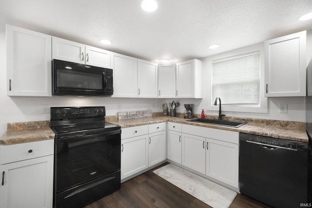 414 Monroe St, Monroeville, IN 46773 - kitchen with black appliances, a sink, dark wood-style flooring, white cabinetry, and recessed lighting