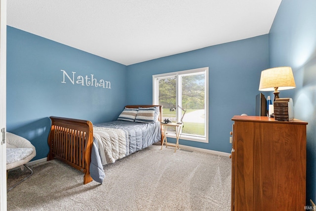 carpeted bedroom featuring baseboards