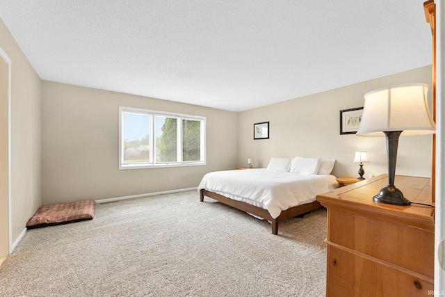 carpeted bedroom featuring baseboards