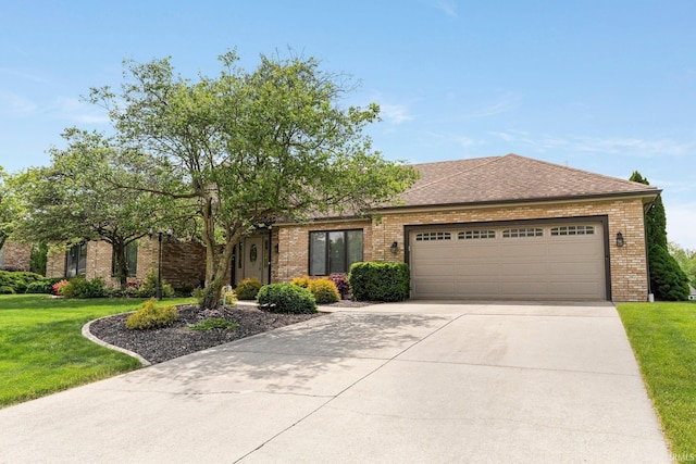 view of front of home featuring brick siding, an attached garage, a front yard, and driveway