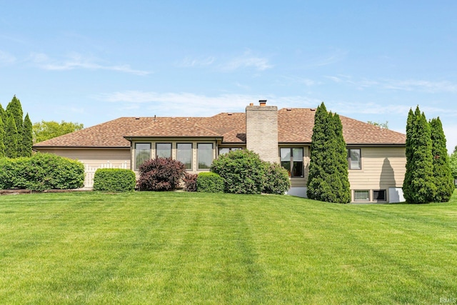 back of property featuring a yard and a chimney