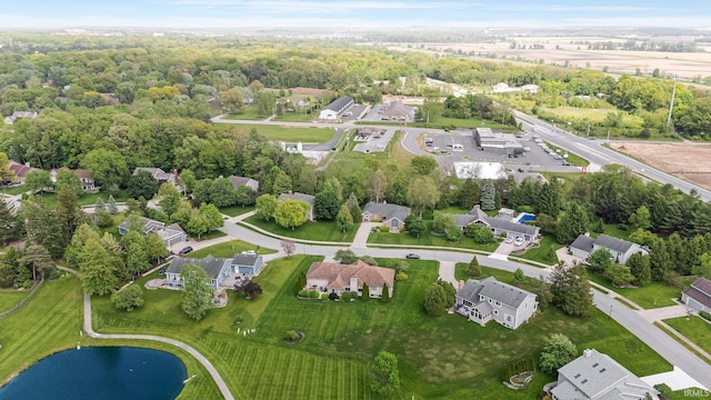 aerial view of property and surrounding area with nearby suburban area and a nearby body of water