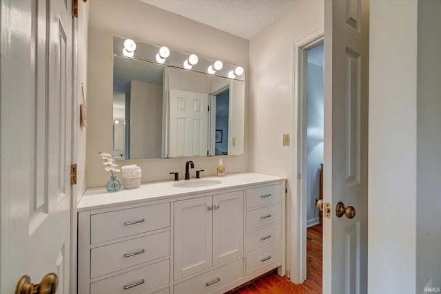 bathroom featuring wood finished floors and vanity