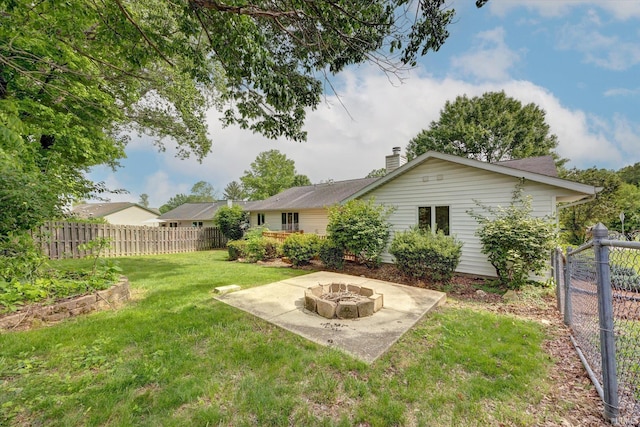 view of yard with a fire pit and a patio