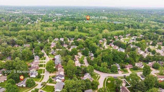 aerial perspective of suburban area featuring a heavily wooded area