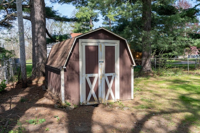 view of shed featuring fence