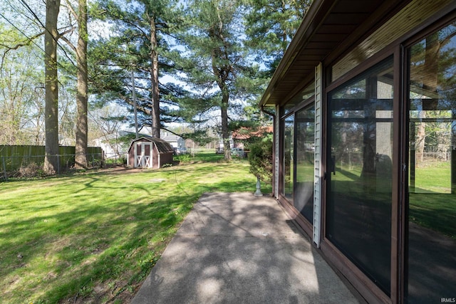 view of yard with a storage shed, an outdoor structure, and a patio