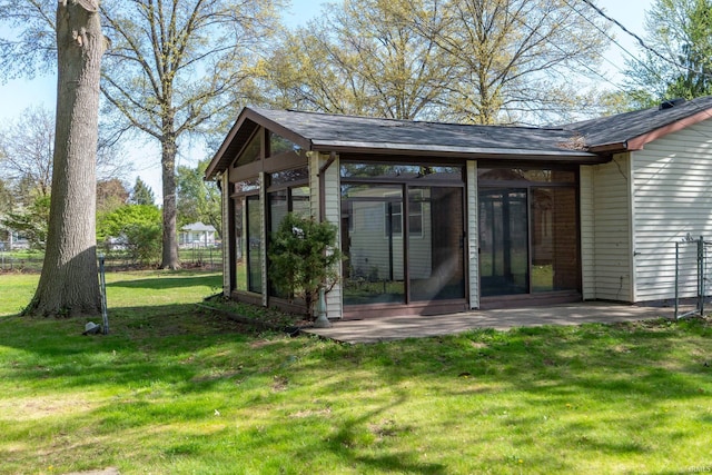 view of outdoor structure featuring a sunroom