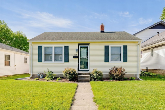 1425 Adams St, Lafayette, IN 47905 - bungalow-style home featuring a chimney, a front yard, and a shingled roof