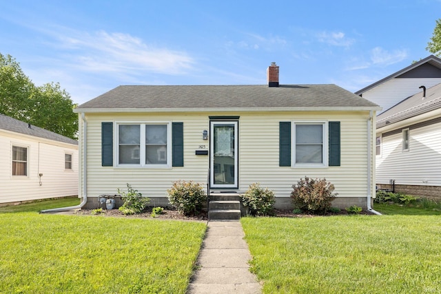 1425 Adams St, Lafayette, IN 47905 - bungalow with a chimney, a front yard, and roof with shingles