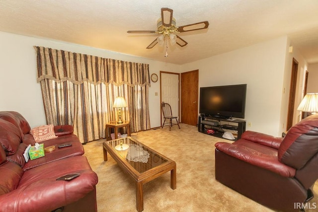 carpeted living room with ceiling fan