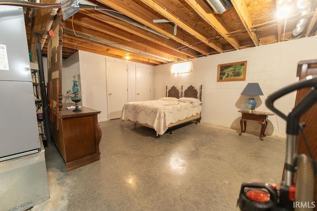 bedroom featuring concrete flooring and heating unit