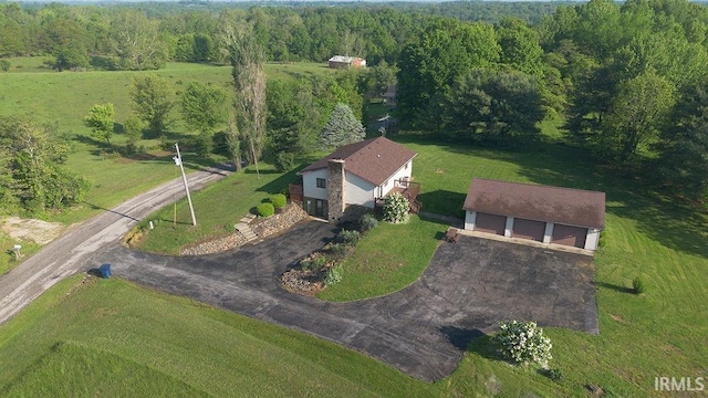 aerial view of property and surrounding area featuring a forest