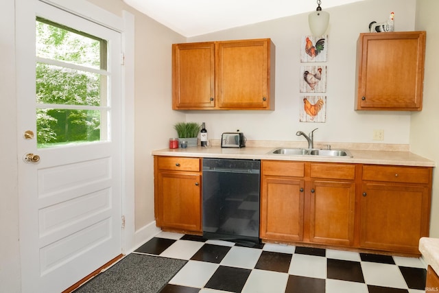 kitchen featuring black dishwasher, a sink, dark floors, light countertops, and vaulted ceiling