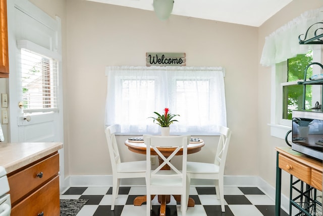 dining room featuring dark flooring and baseboards