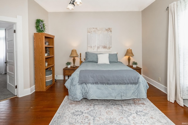 bedroom featuring wood finished floors and baseboards