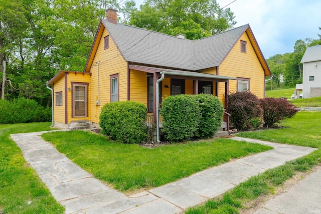 bungalow-style house featuring a chimney, a front lawn, a shingled roof, and a porch