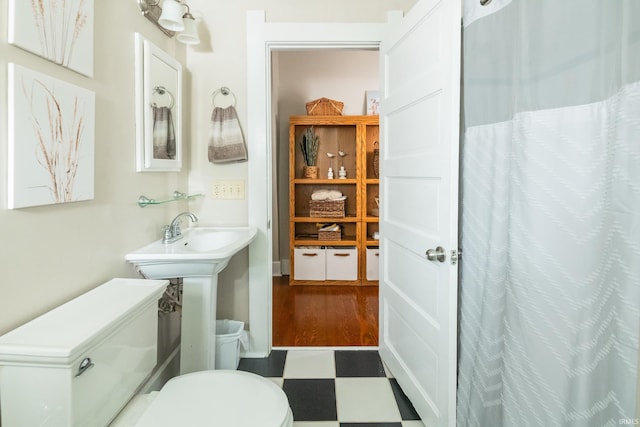 full bath featuring tile patterned floors, toilet, and curtained shower