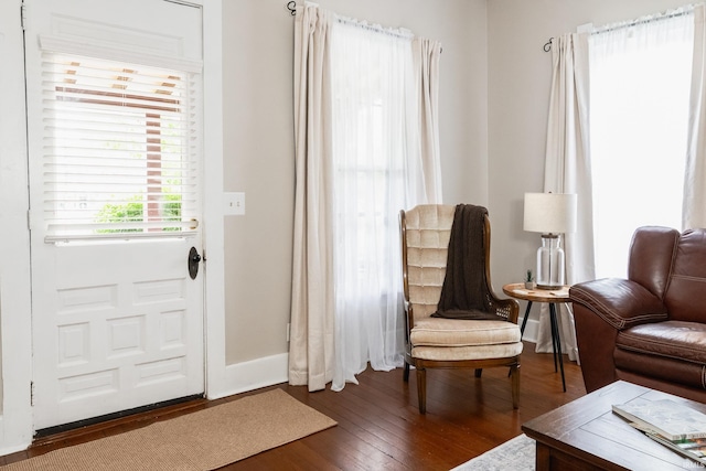 foyer entrance featuring wood finished floors and baseboards