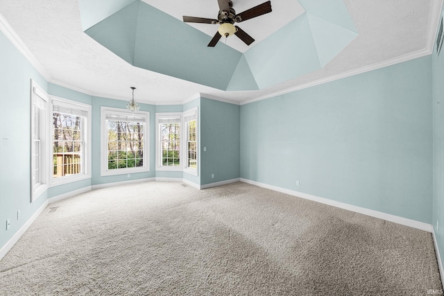spare room featuring carpet flooring, ornamental molding, a ceiling fan, and baseboards