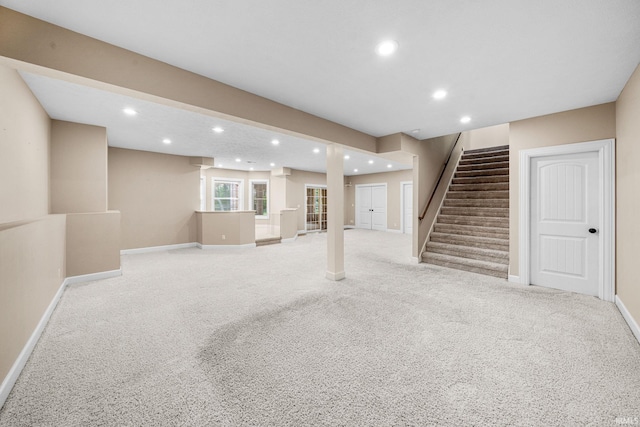 basement featuring stairway, recessed lighting, carpet floors, and baseboards