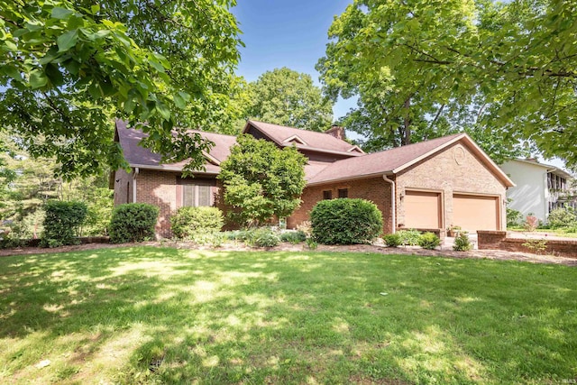 view of front of property with brick siding, a front lawn, and a garage