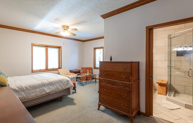 bedroom featuring ornamental molding, light carpet, ensuite bath, and ceiling fan