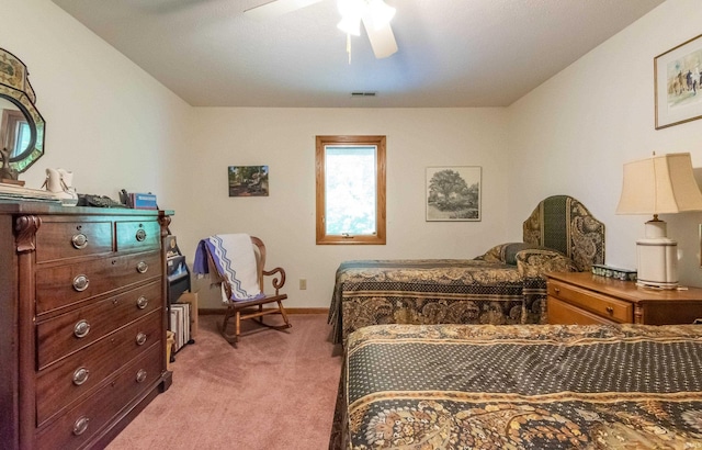 bedroom with light colored carpet, baseboards, and ceiling fan
