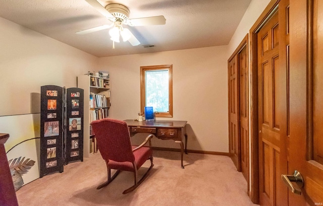 office area featuring light colored carpet and a ceiling fan