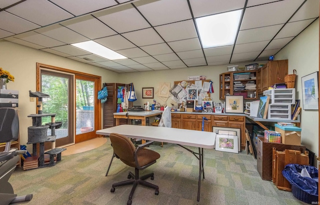 office area featuring light carpet and a paneled ceiling