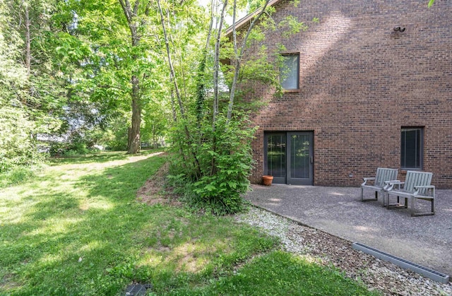 view of green lawn with a patio