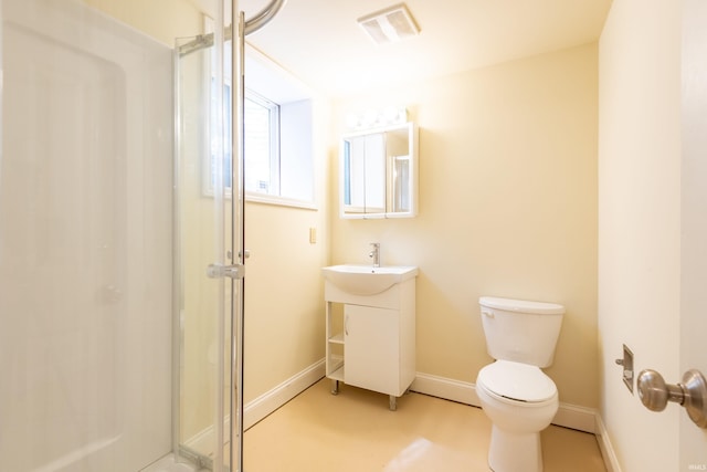 full bathroom with toilet, a shower stall, baseboards, and vanity
