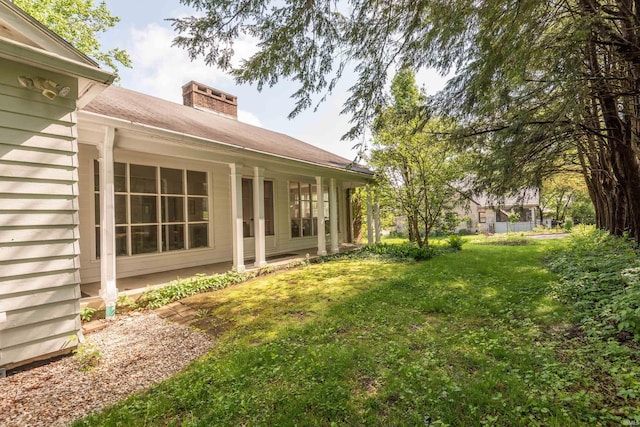 view of green lawn featuring a porch