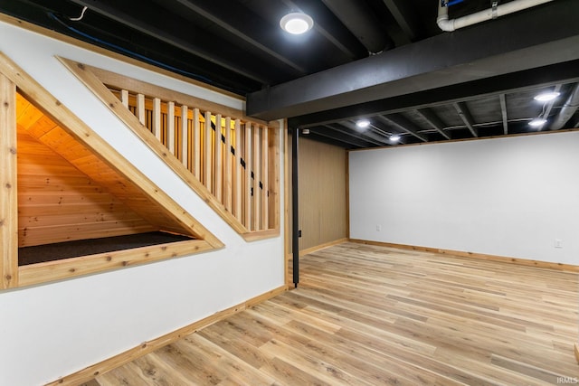 finished basement with baseboards and wood finished floors