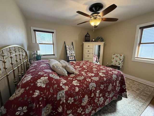 2110 Denson Ave, Bedford, IN 47421 - bedroom with multiple windows, baseboards, and a ceiling fan