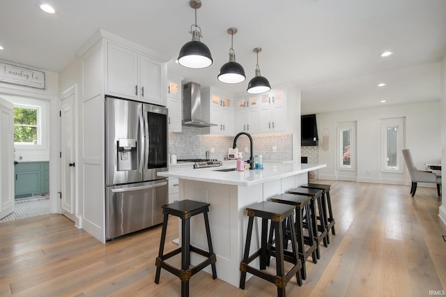 4 Edgewater Pl, Elkhart, IN 46516 - kitchen with stainless steel fridge, wall chimney range hood, light wood-style floors, decorative backsplash, and recessed lighting