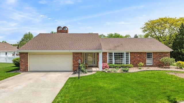 view of front of house featuring a garage, a chimney, concrete driveway, and a front yard