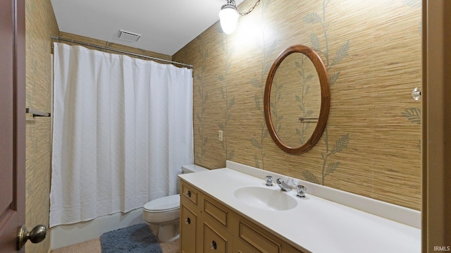 full bathroom featuring toilet, vanity, and wallpapered walls
