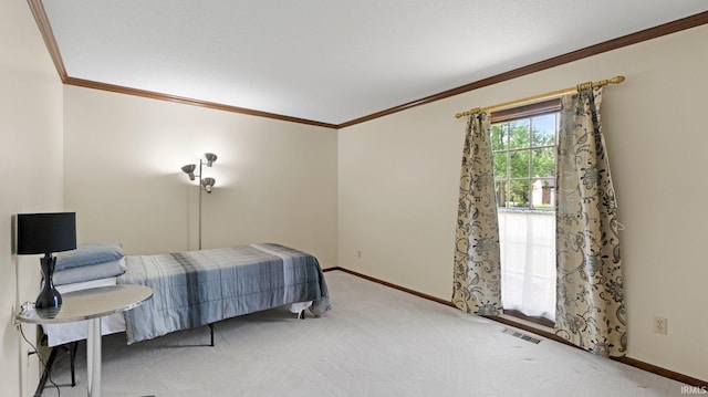bedroom featuring crown molding, carpet flooring, and baseboards