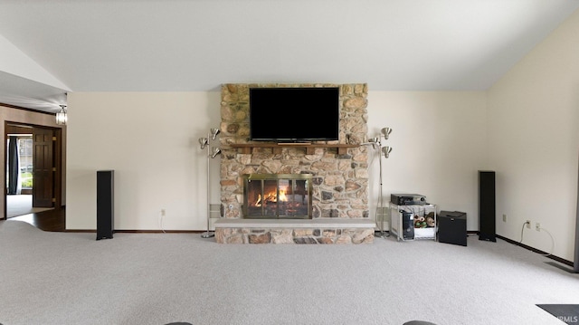 unfurnished living room featuring carpet floors, a stone fireplace, vaulted ceiling, and baseboards