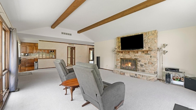 living area with light carpet and a fireplace