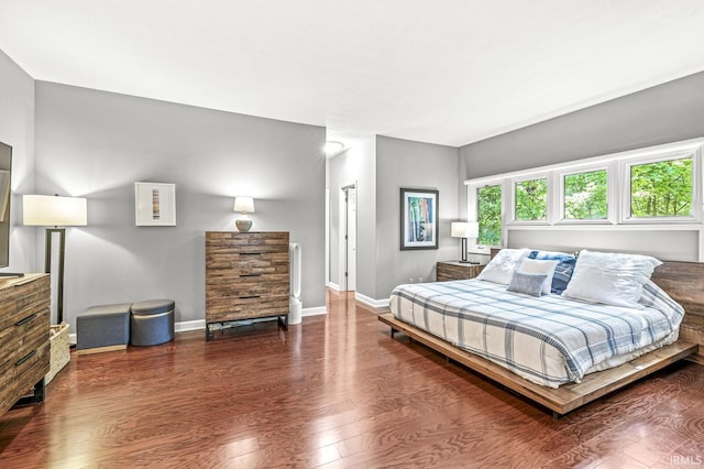 bedroom featuring wood finished floors and baseboards