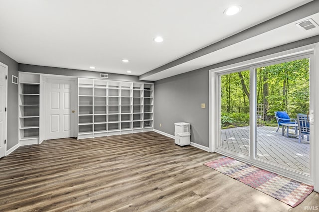unfurnished living room featuring baseboards, wood finished floors, and recessed lighting